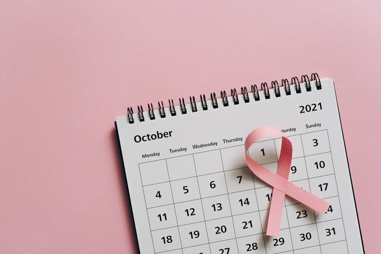 Pink ribbon on October calendar symbolizes breast cancer awareness.